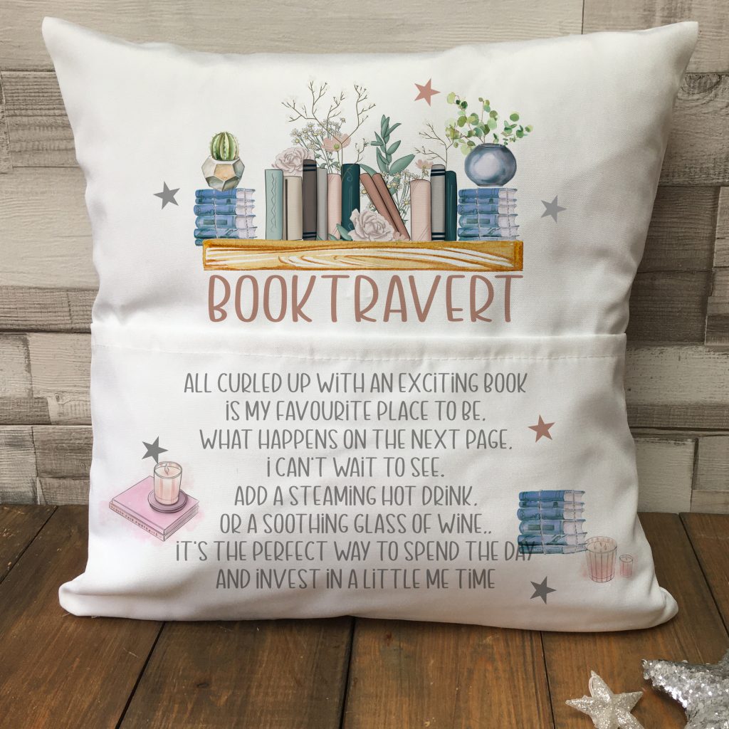 White reading cushion with an image of books on a shelf with the words "Booktravert" followed by a section of wording.