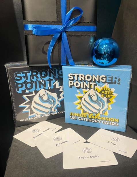 Strong Point Games boxes with example playing cards displayed in front of the box