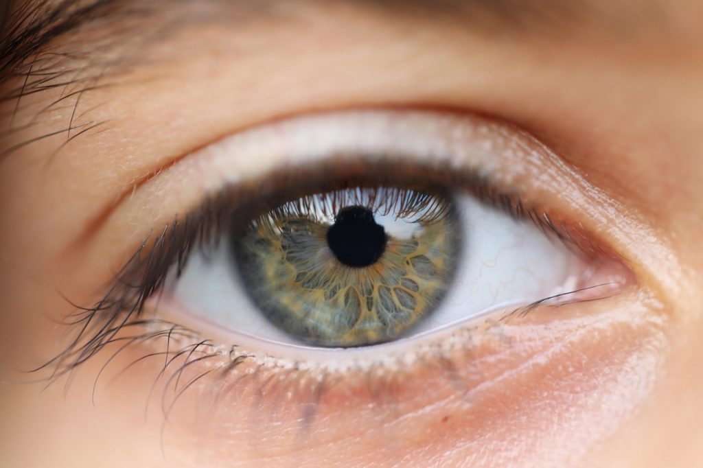 A close-up of a hazel-coloured eye representing the benefits of laser eye surgery for parents