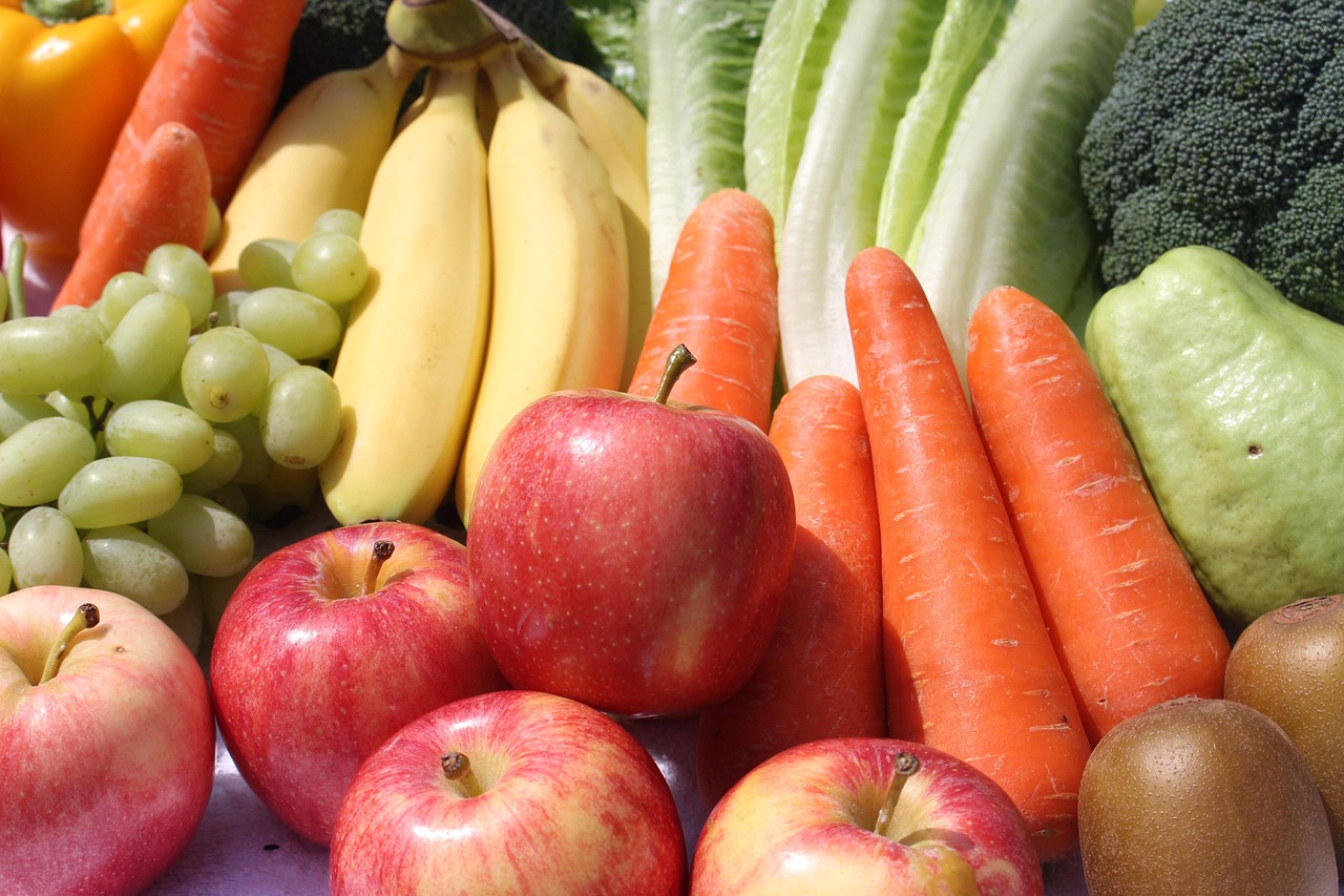 A range of fruit and vegetables including apples, bananas, carrots and grapes