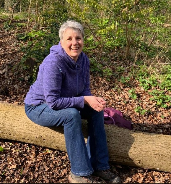 Beckie Whitehouse sitting on a log