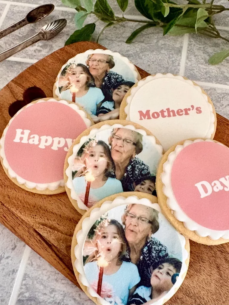 Six large cookies, 3 with photos, 3 spelling out the words "Happy Mother's Day"