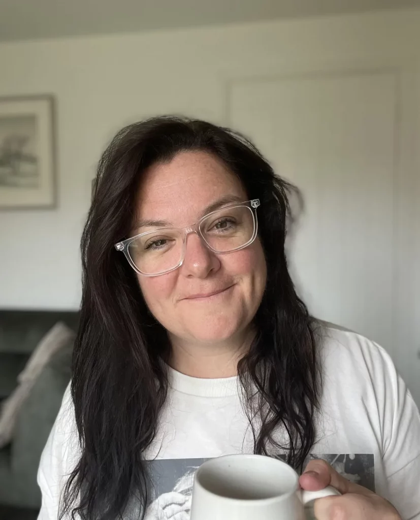 Headshot of Liz Evans, the dyslexia OT wearing a white t-shirt, holding a cup.