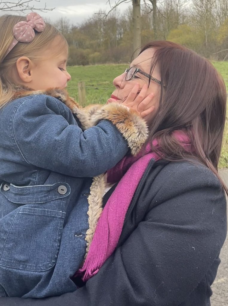 Gem from Wild at Heart carrying her daughter who is playing with Gem's face