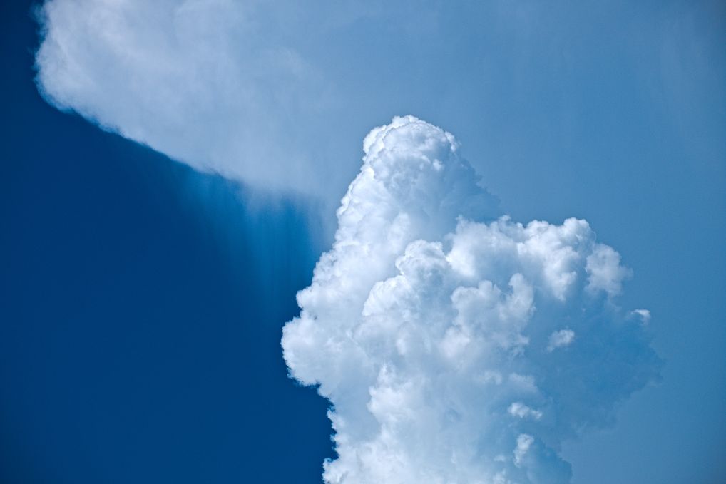 White clouds loosely in a heart shape against a blue sky